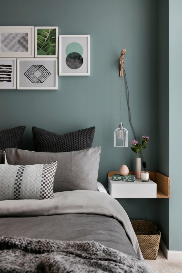 a Scandinavian bedroom designed with teal wall and fossil gray bed cotton
