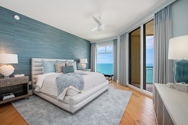 a beach-style guest bedroom with the cerulean teal and gray wall