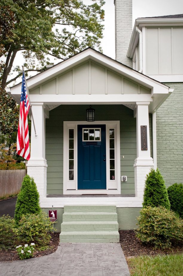 a craftsman single front door in a rainstorm dark blue color