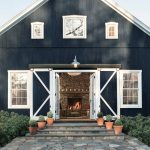 a hale navy blue benjamin moore barn styled front door in a rustic farmhouse property