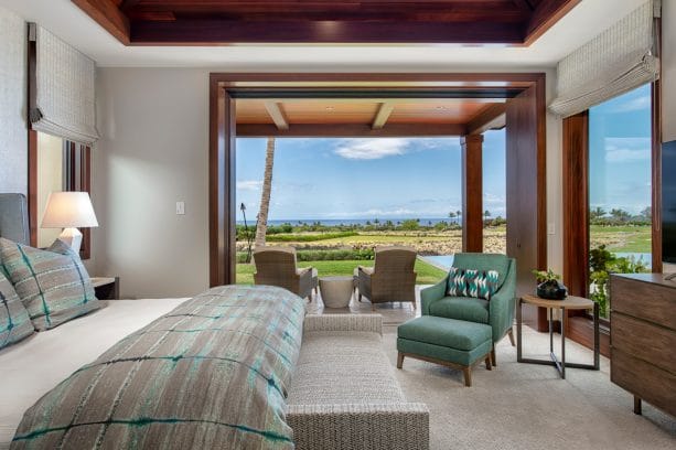 a tropical style bedroom with the gray wall and gray-teal bed cover