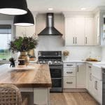 all white cabinet open space modern farmhouse kitchen and dining room combo with black appliances