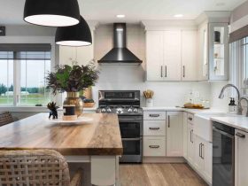 all white cabinet open space modern farmhouse kitchen and dining room combo with black appliances