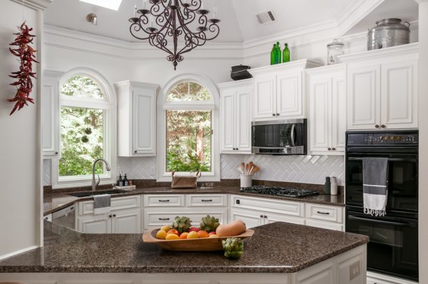 an octagon kitchen shape matched black stove and white raised-panel cabinets