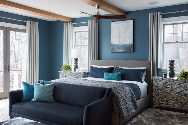 beach-style master bedroom with the cerulean wall, ash-gray carpeted, and charcoal and fossil bed