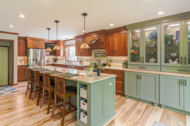 combination of wooden and sage green cabinets in a craftsman kitchen
