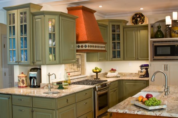 edgy and romantic kitchen with sage green cabinets in a french country style