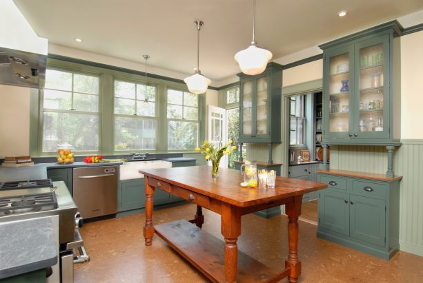 lovely rustic kitchen furnished by sage green cabinets and stainless steel appliances