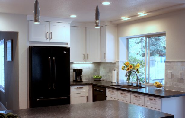 mid-sized transitional kitchen design combines black appliances and clear white cabinets