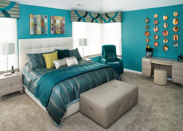 mid-sized trendy master bedroom with teal walls and full ash gray carpet tile
