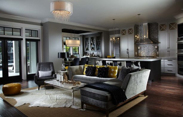 open concept living room with combination of gray, gold, and black