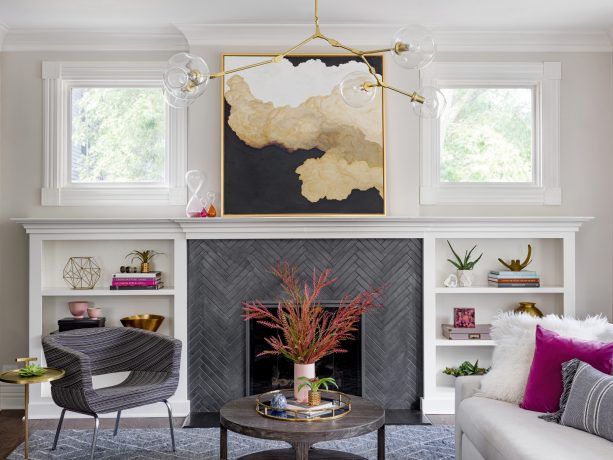 a herringbone tile fireplace with low built-in shelves around