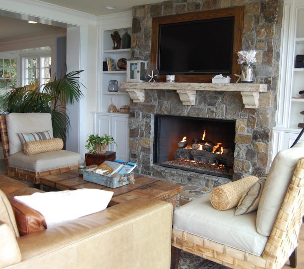 canyon creek stone fireplace with neutral colored built-in shelves around