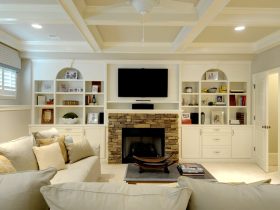 combination of fieldstone fireplace and polished white built-in shelves around