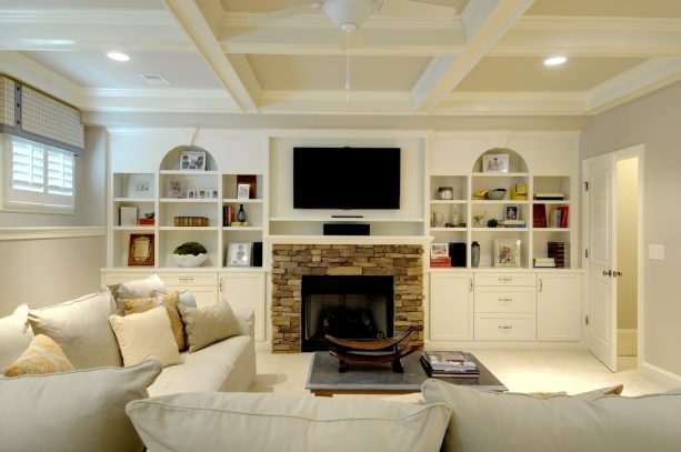 combination of fieldstone fireplace and polished white built-in shelves around