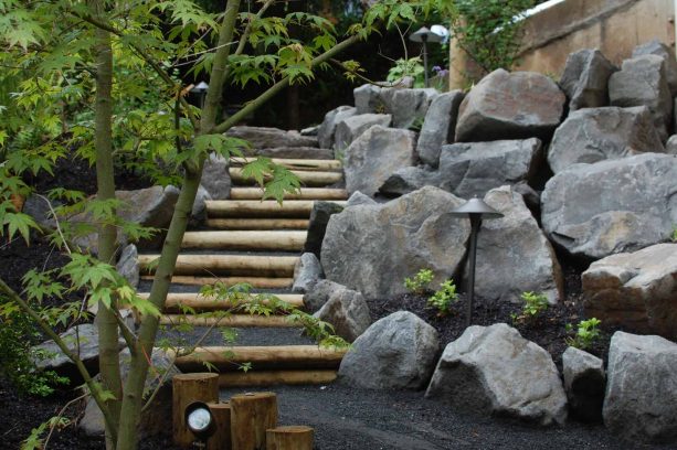 combination of wood and stone steps landscape to conquer steep slope