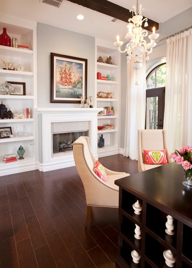 crisp white fireplace with tiles surround and built-in shelves around