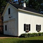 farmhouse two-story garage apartment with black metal roofing