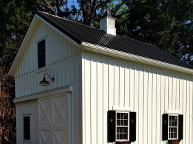 farmhouse two-story garage apartment with black metal roofing
