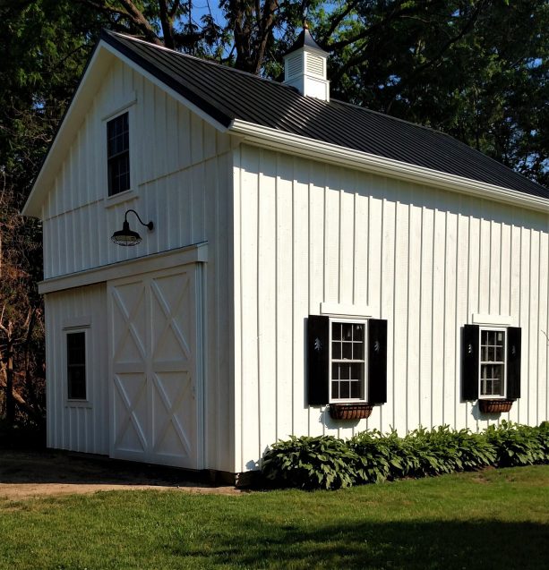 farmhouse two-story garage apartment with black metal roofing