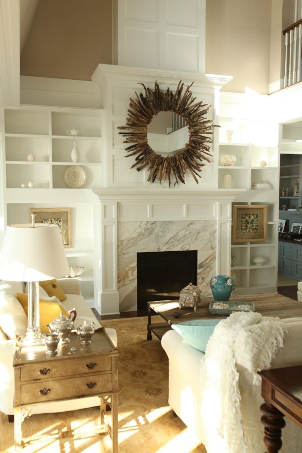 glacier white built-in shelves around a calcutta gold marble fireplace