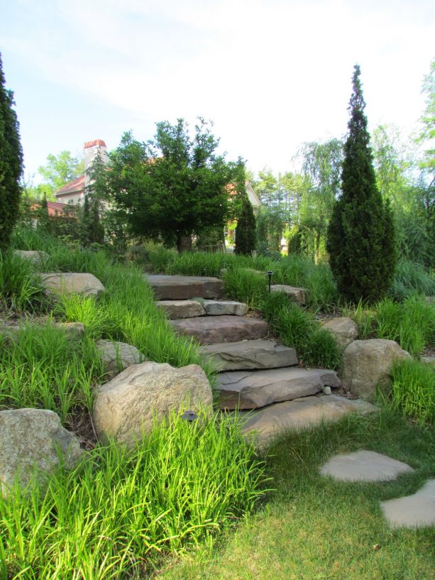 mediterranean hillside slope landscaping with colonial steppers stone steps