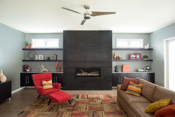 modern living room with black fireplace and built-in shelves around