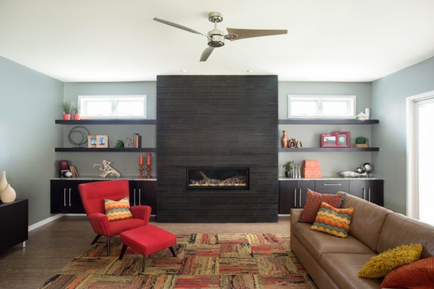 modern living room with black fireplace and built-in shelves around