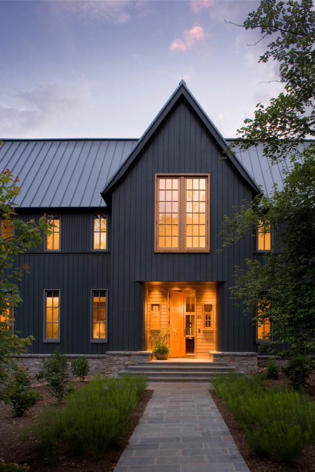 transitional house with a combination of metallic grey metal roof and hague blue estate emulsion color paint siding