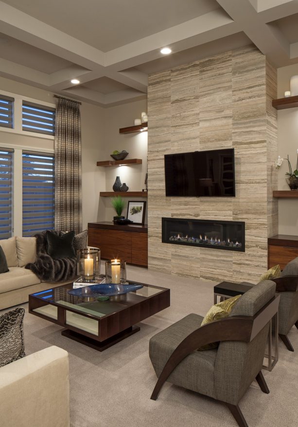 trendy carpeted living room with floating built-in shelves around fireplace feature