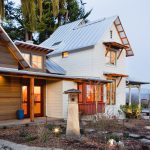 victorian farmhouse with a metal roof and white siding combination