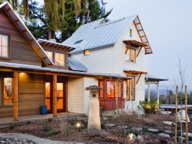 victorian farmhouse with a metal roof and white siding combination