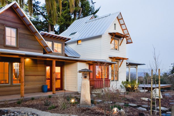 victorian farmhouse with a metal roof and white siding combination