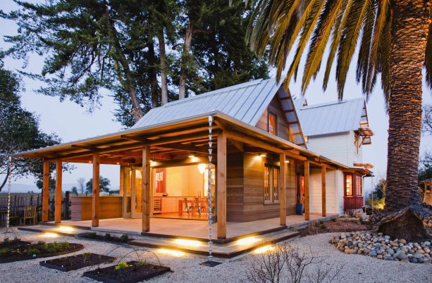 vintage victorian farmhouse with a metal roof and stained cedar siding combination