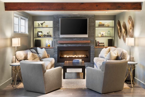wood built-in shelves around a stone fireplace