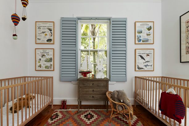 a traditional nursery interior design with light blue internal shutter and white wall