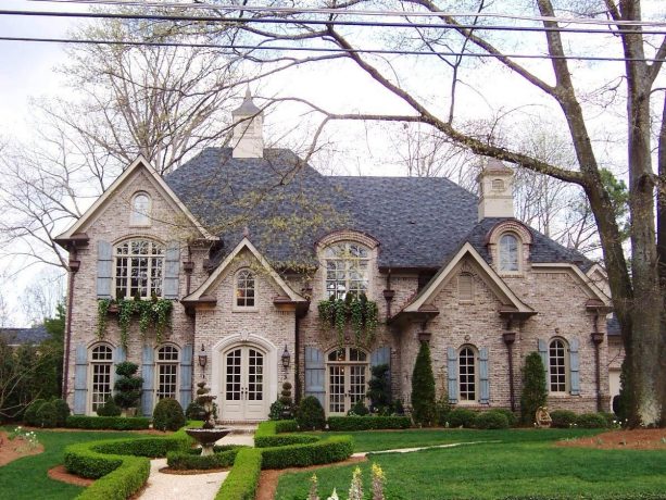 lovely vintage brick house with arched windows and shutters