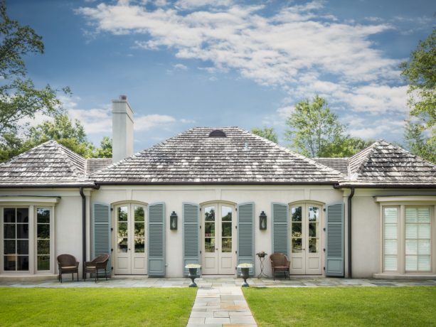 mid-size traditional white house with external blue shutters