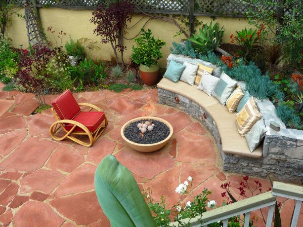 mid-sized tuscan backyard featuring stone paver patio and circular fire pit table