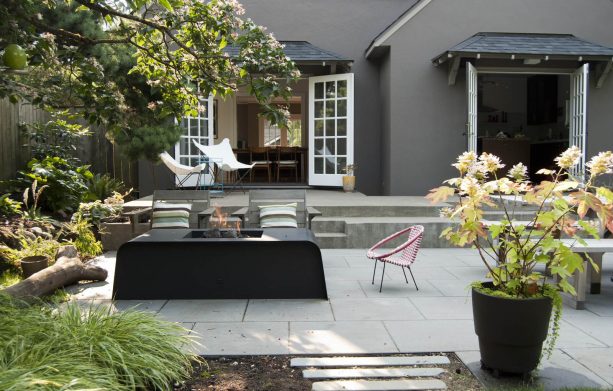 modern patio with concrete paver and black metal fire pit