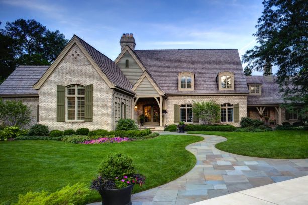 painted brick house exterior with mossy green shutters