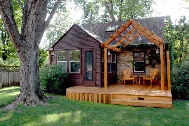 small raised pergola with post and beam structure attached to roof