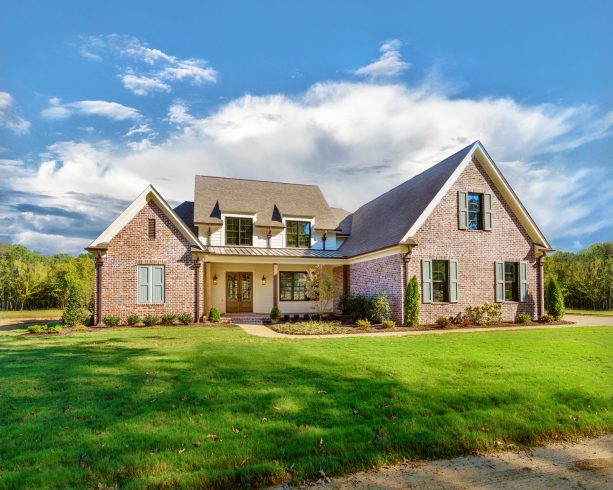 tavern hall brick house in farmhouse style completed with pale green shutters