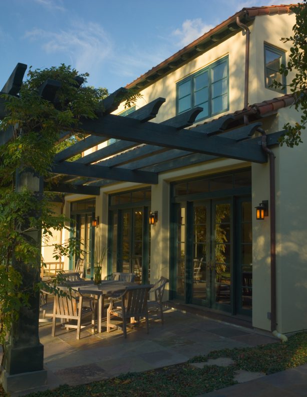 tuscan style pergola attached to a copper roof