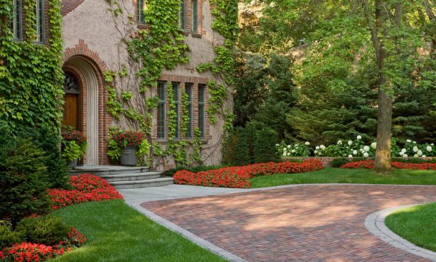 bluestone paver steps accentuated by flowers against the two-story house