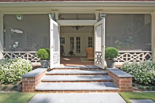 bricks covered with bluestone paver steps against a traditional porch of a house