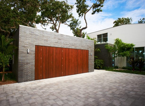 cedar flat panel garage door installed with endicott brick surround