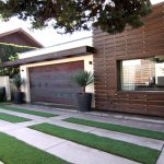 copper flat panel one car garage door side by side with a redwood siding