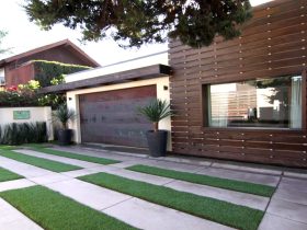 copper flat panel one car garage door side by side with a redwood siding