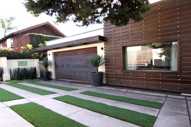 copper flat panel one car garage door side by side with a redwood siding